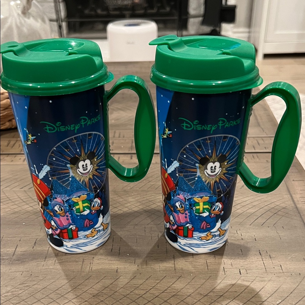 2 Disney Parks Blue and Green Christmas Travel Mugs (2023). GUC